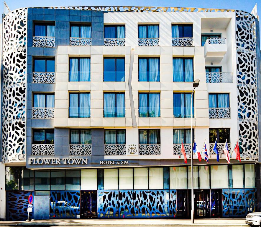 een gebouw met een bord aan de voorkant bij Flower Town Hotel & Spa in Rabat