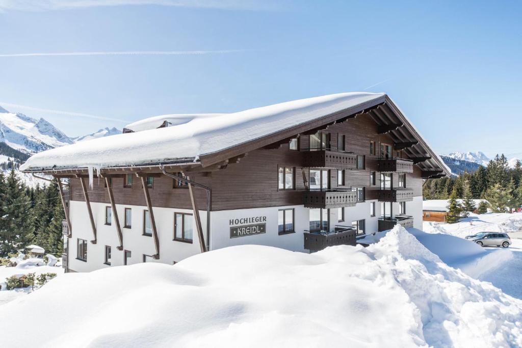 a snow covered building with a pile of snow at Haus Kreidl - Top 38 in Königsleiten