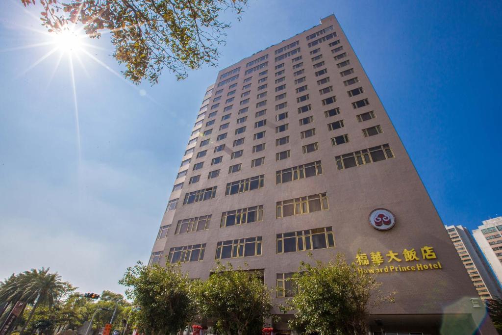 a tall building with the sun in the sky at The Howard Prince Hotel Taichung in Taichung