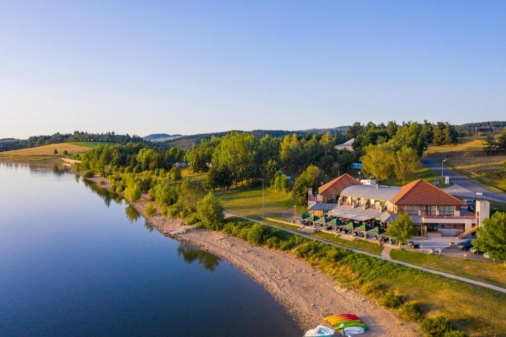 an aerial view of a river with a resort at Les Lofts du Grand Lac de Lozère in Langogne