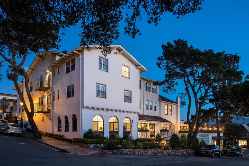 a white building on a street at night at Pine Inn - Carmel in Carmel