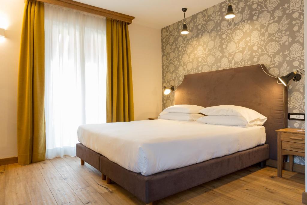 Postel nebo postele na pokoji v ubytování Duca D'Aosta Hotel