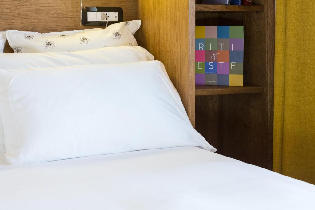 Postel nebo postele na pokoji v ubytování Duca D'Aosta Hotel