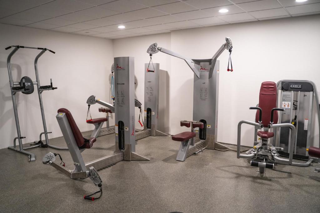 a gym with several treadmills and cardio machines at Hótel Dyrhólaey in Vík