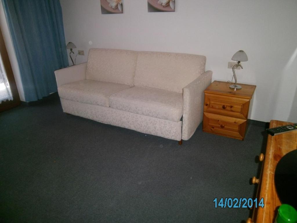 a living room with a couch and a table at Gästehaus Hirschenhof in Sölden