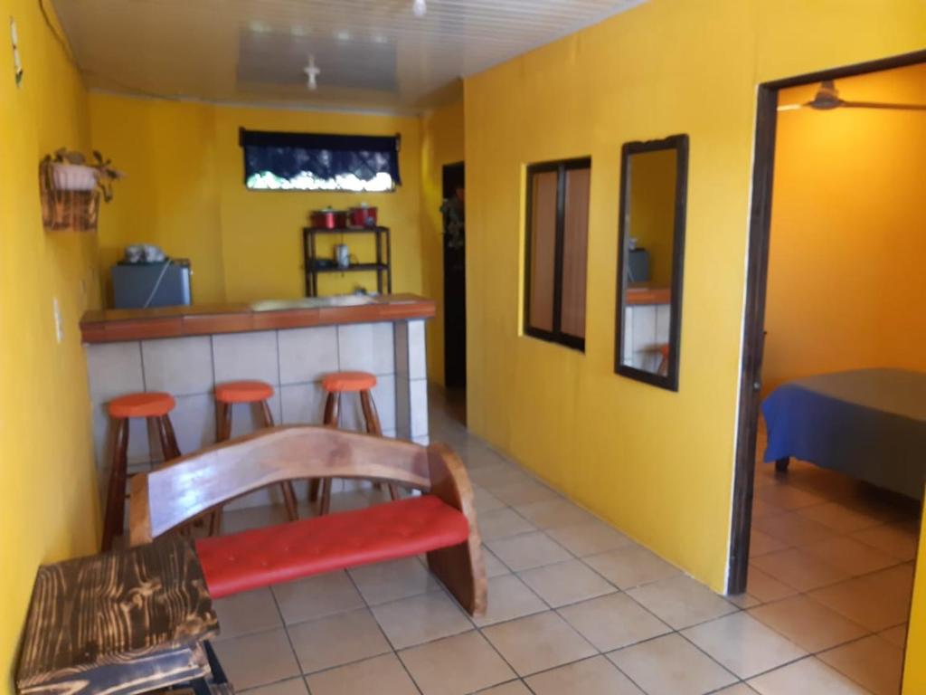 a kitchen with a bar and stools in a room at ALBA´S RENT in Quepos