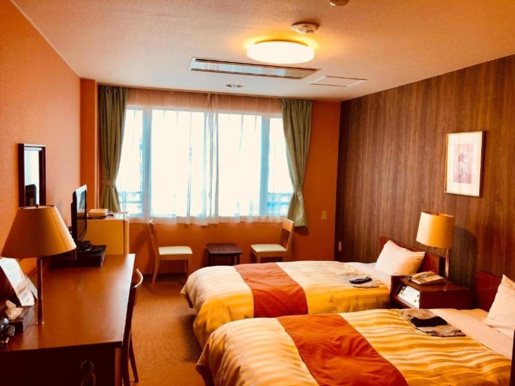 a hotel room with two beds and a window at Fuji Green Hotel - Vacation STAY 18934v in Fuji