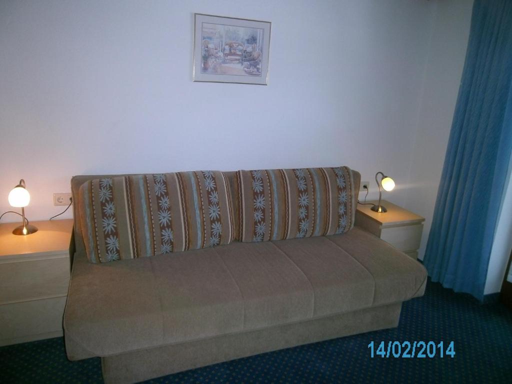 a couch in a room with two tables and two lamps at Gästehaus Hirschenhof in Sölden