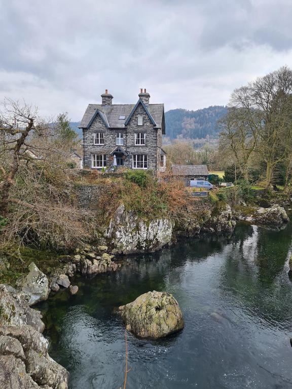 a house on a hill next to a river at Bryn Afon in Betws-y-coed