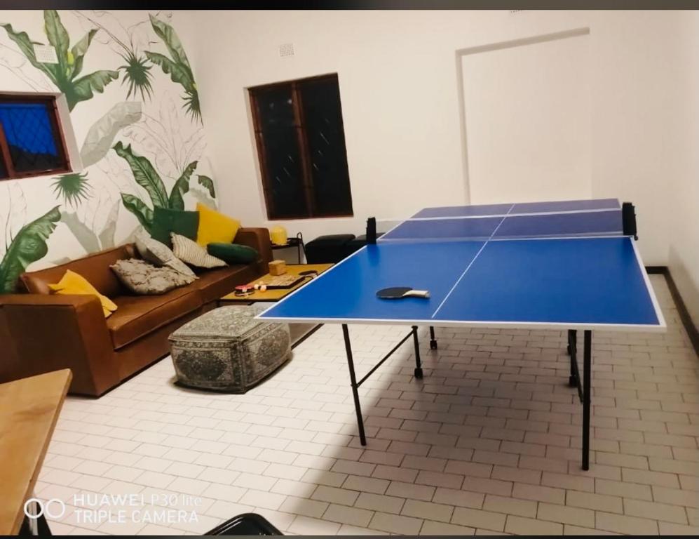 a blue ping pong table in a living room at Beautiful Villa - Scottburgh, Durban in Scottburgh