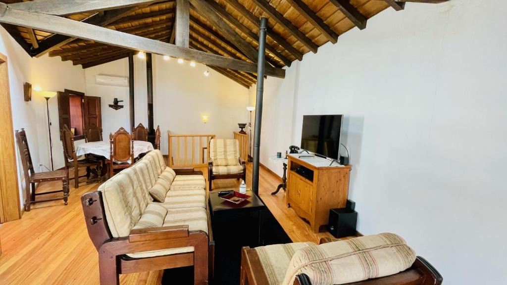 a living room with a couch and a tv at Casa do Avô in Sistelo