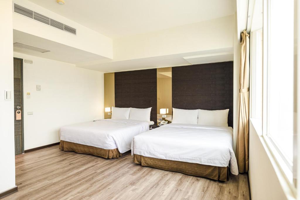 Postel nebo postele na pokoji v ubytování Jih Lih Hotel