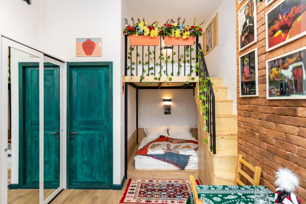 een slaapkamer met een stapelbed en een groene deur bij Studio Orbeliani in Tbilisi City