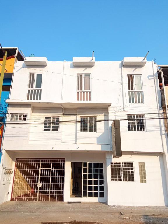 a white building with a lot of windows at Hotel Posada del Ángel in Villahermosa