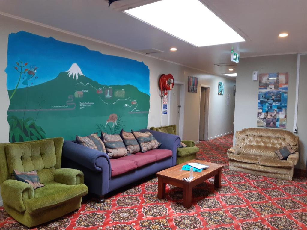 a living room with a couch and two chairs at Ariki Backpackers in New Plymouth