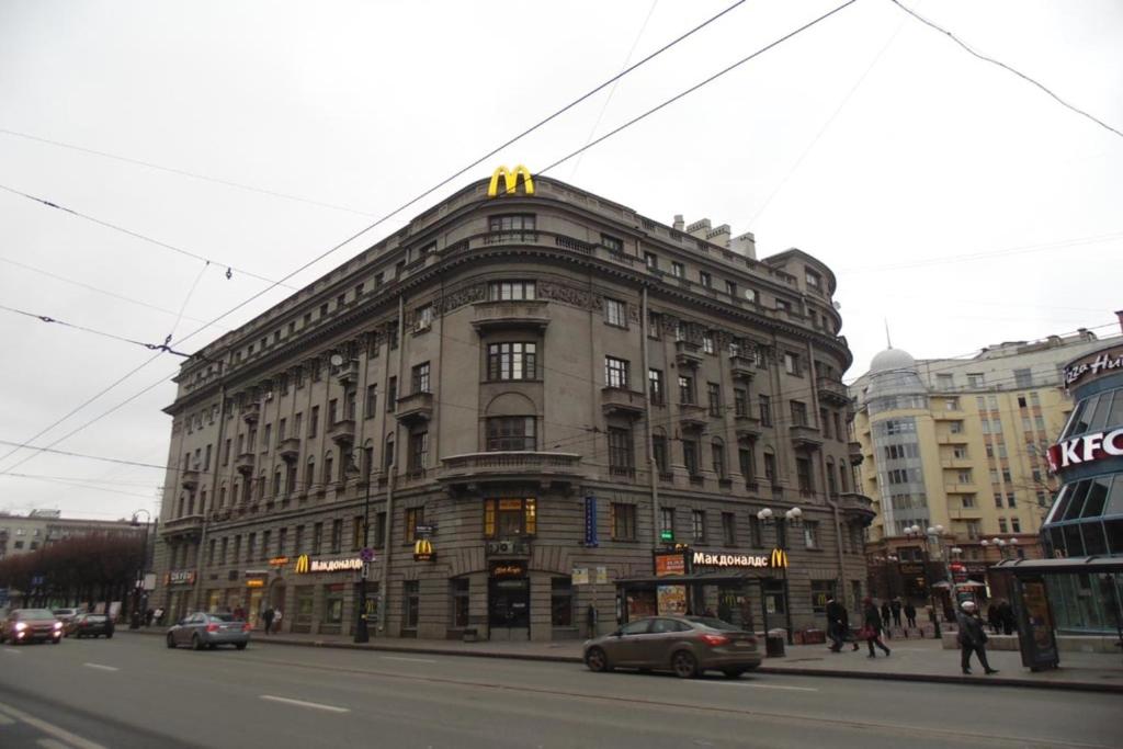 a large building on the corner of a city street at Acme Petrogradskaya in Saint Petersburg