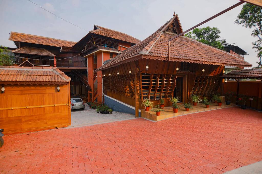 a building with a red brick driveway in front of it at JK Lodge in Kottayam