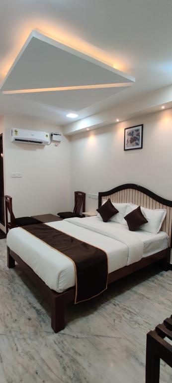 a bedroom with a large bed in a room at Rmc travellers inn in Chennai