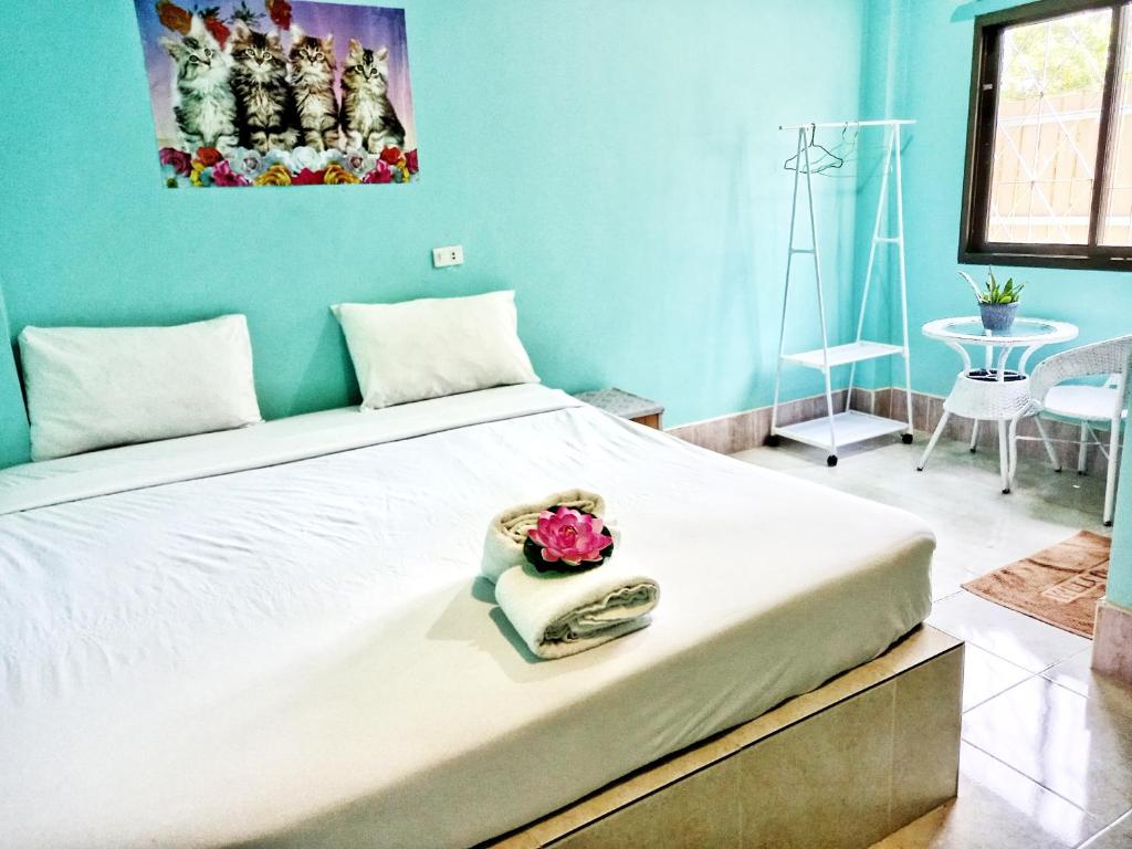 a bedroom with a large white bed in a room at Stella Resort Khanom in Khanom