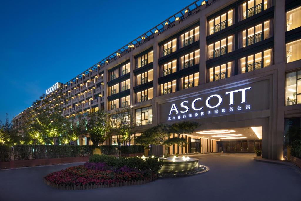 an exterior view of an asot hotel at night at Ascott Riverside Garden Beijing in Beijing