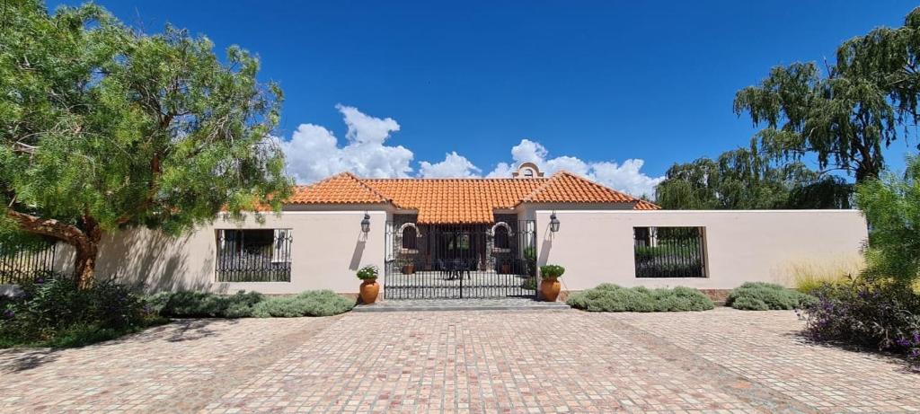 a house with a brick driveway in front of it at Casa Hortensia by Cafayate Holiday in Cafayate