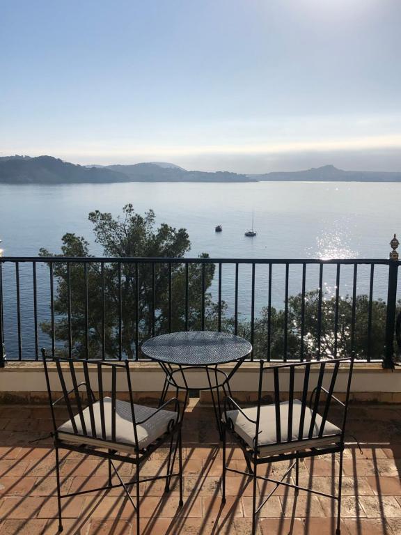a table and chairs on a balcony with a view of the water at Hotel Cala Fornells in Paguera