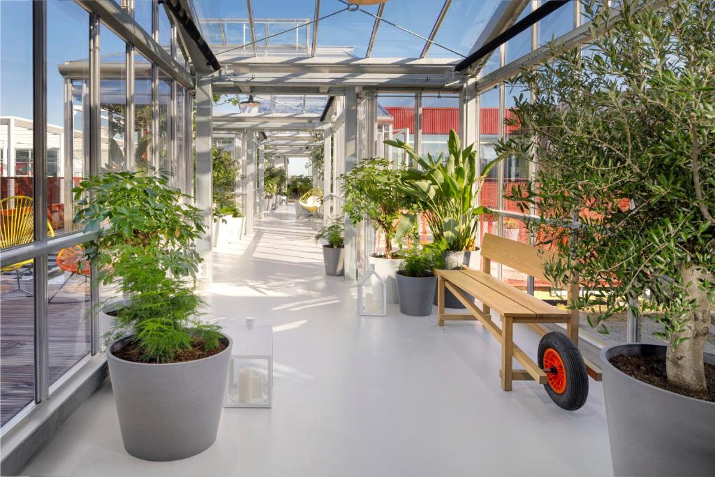 a room with a bunch of plants in it at Zoku Copenhagen in Copenhagen