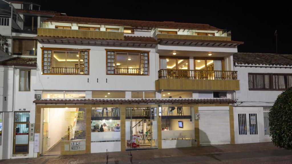 a large white building with a lot of windows at Hotel Boutique San Marcos Chiquinquirá in Chiquinquirá