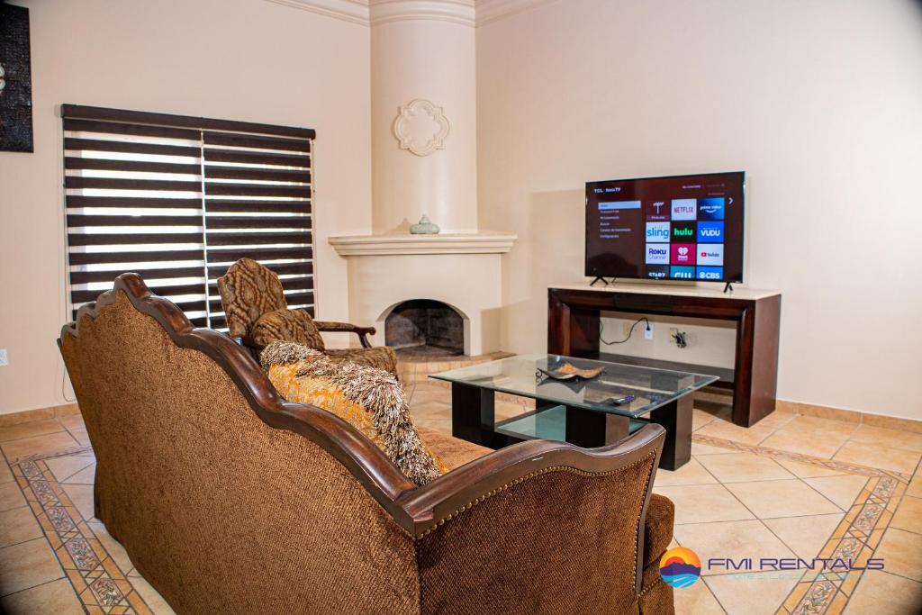 a living room with a couch and a tv at Casa Costa Diamante F27 in Puerto Peñasco