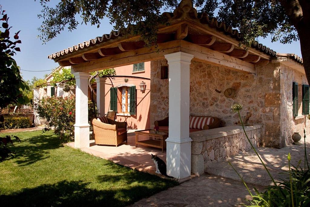 a gazebo with a bench in a yard at Can Cremat in Port de Pollensa