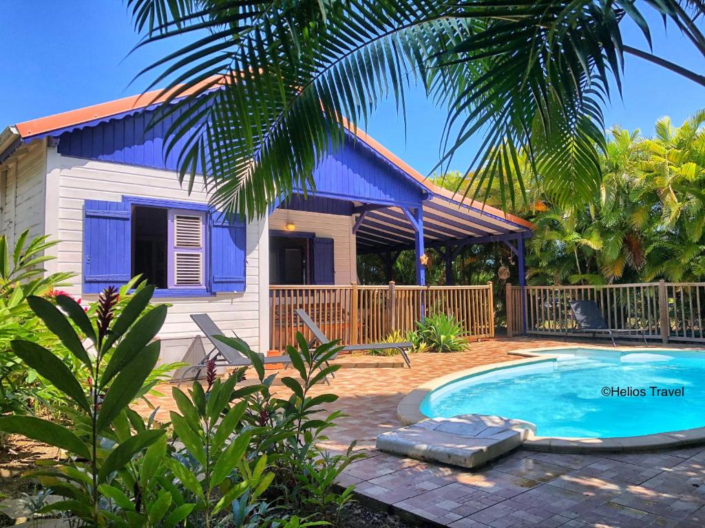 a house with a swimming pool in front of it at Villa Deshaies in Deshaies