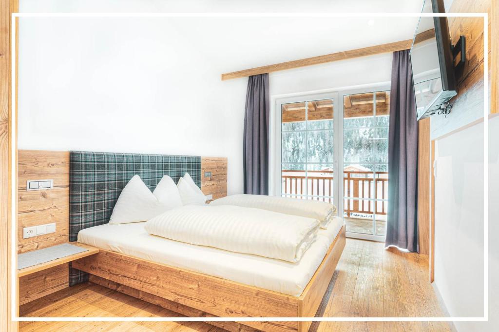 Postel nebo postele na pokoji v ubytování Tyrol Mountain Aparts - Urlaubsresort Hafele