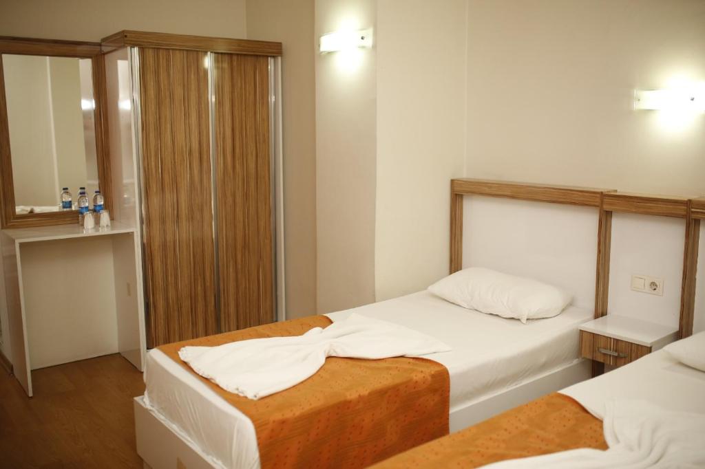 Postel nebo postele na pokoji v ubytování Özhan Hotel