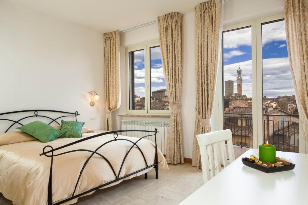 a bedroom with a bed and a view of the city at B&B I Tetti di Siena in Siena