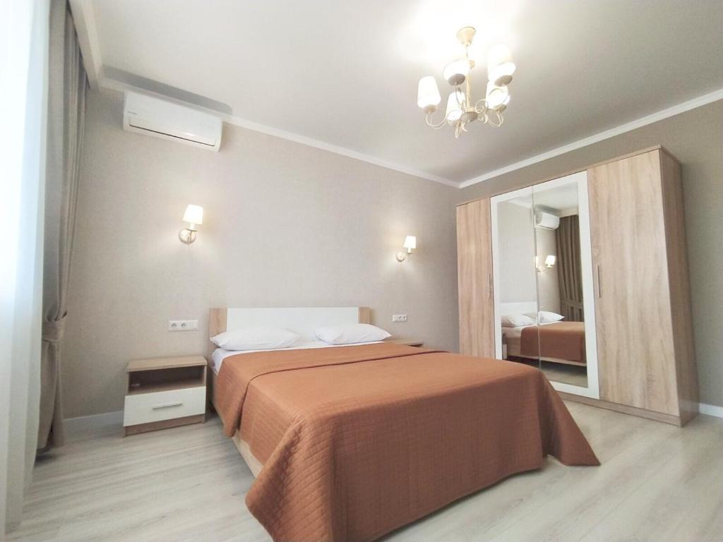 - une chambre avec un grand lit et un miroir dans l'établissement квартира в Жилом комплексе Левитана,массив Радужный, à Odessa