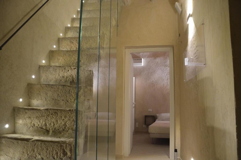 
a bathroom with a stairway leading up to the stairs at Secret B&B in Trapani
