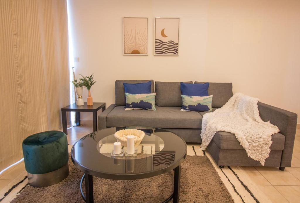 a living room with a couch and a table at Marina View! 3 mins to the Tram - Damac Waves in Dubai