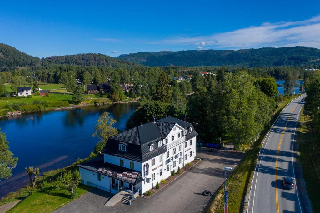 an aerial view of a building next to a river at Dølen Hotel in Evje