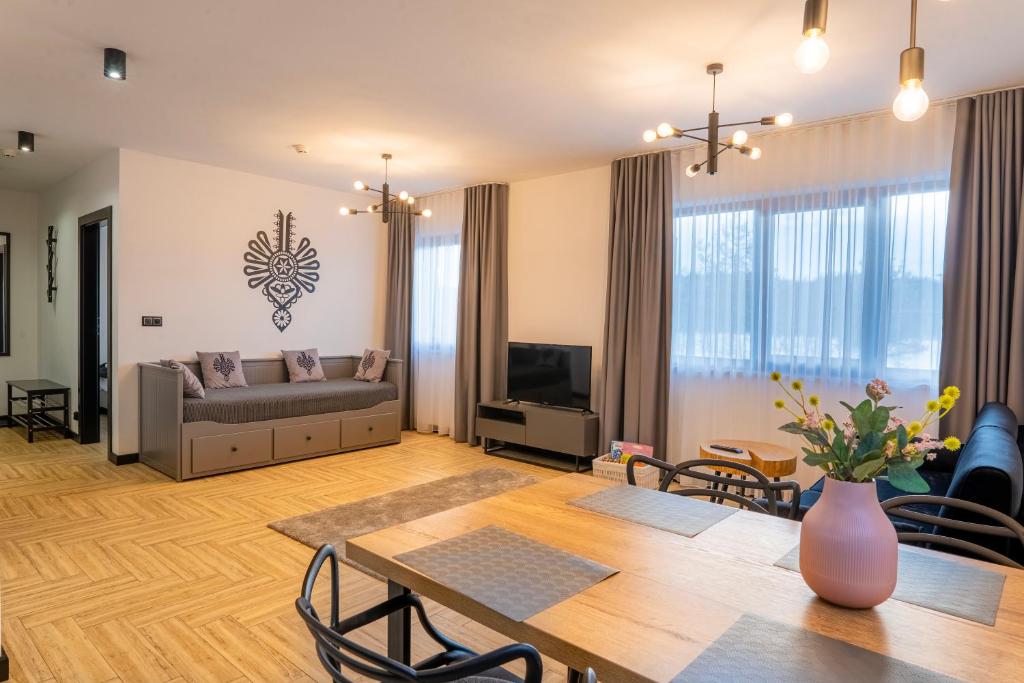 a living room with a table and a couch at Apartament w Kluszkowcach nad Jeziorem Czorsztyńskim in Kluszkowce