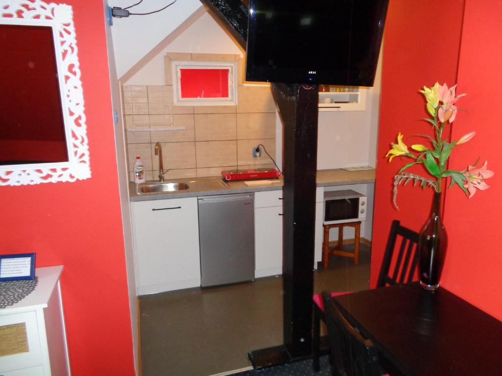 a kitchen with a table and a tv in a room at Apartamenty Wyspiańskiego in Świnoujście