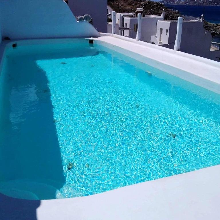 a swimming pool with blue water in a house at 4BD Blue Dream Mykonos in Mikonos