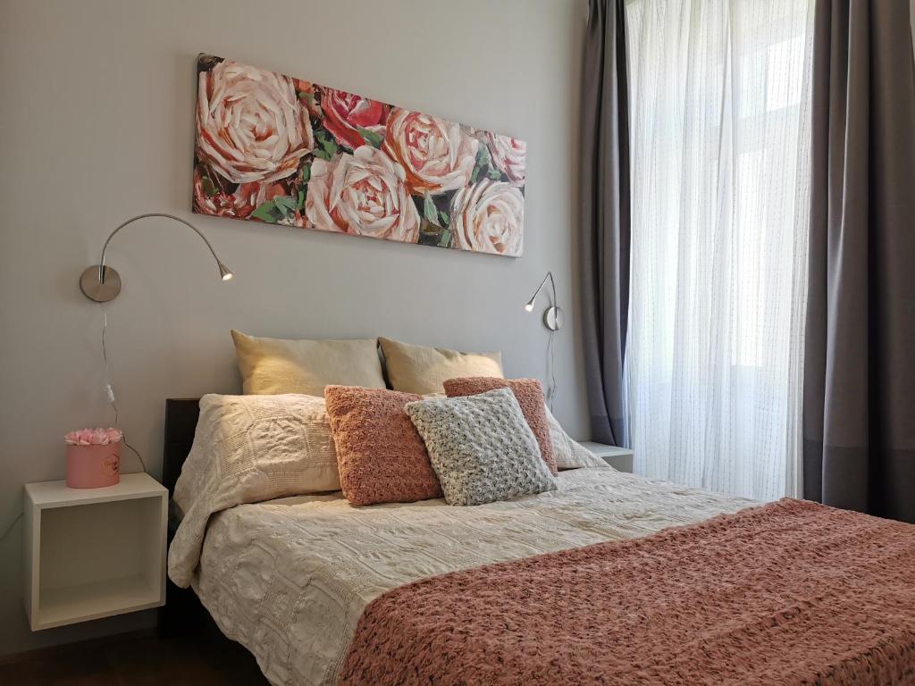 a bedroom with a bed with a painting on the wall at Apartment Heart of Old Town in Pula