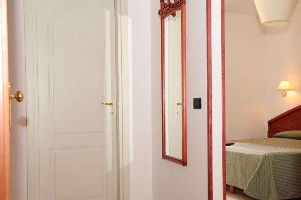 Łóżko lub łóżka w pokoju w obiekcie Hotel Villa Rosa