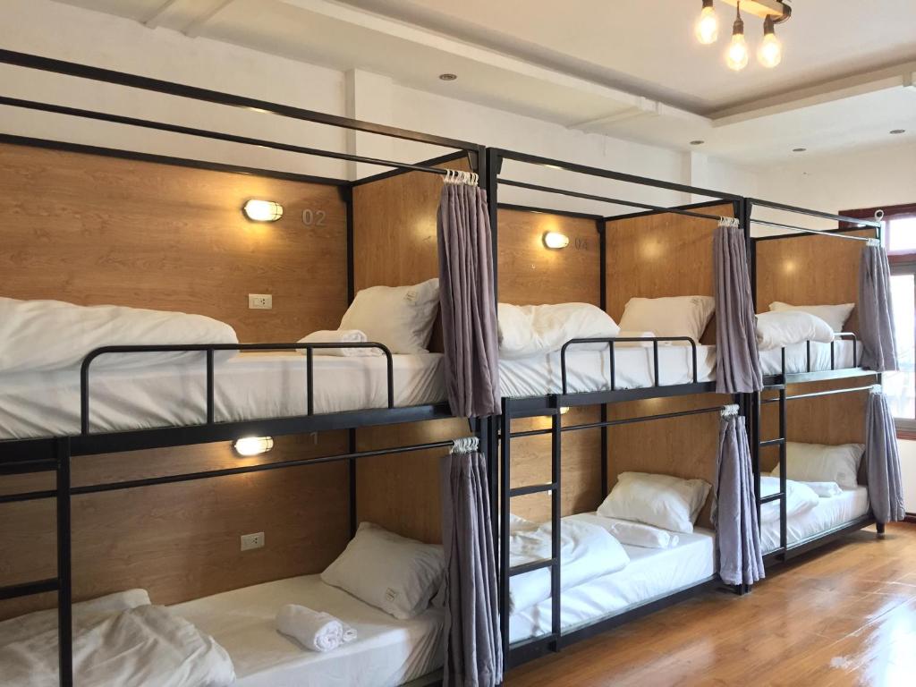 a group of bunk beds in a room at An Homestay & Hostel Motorbikes & Tours in Cao Bằng