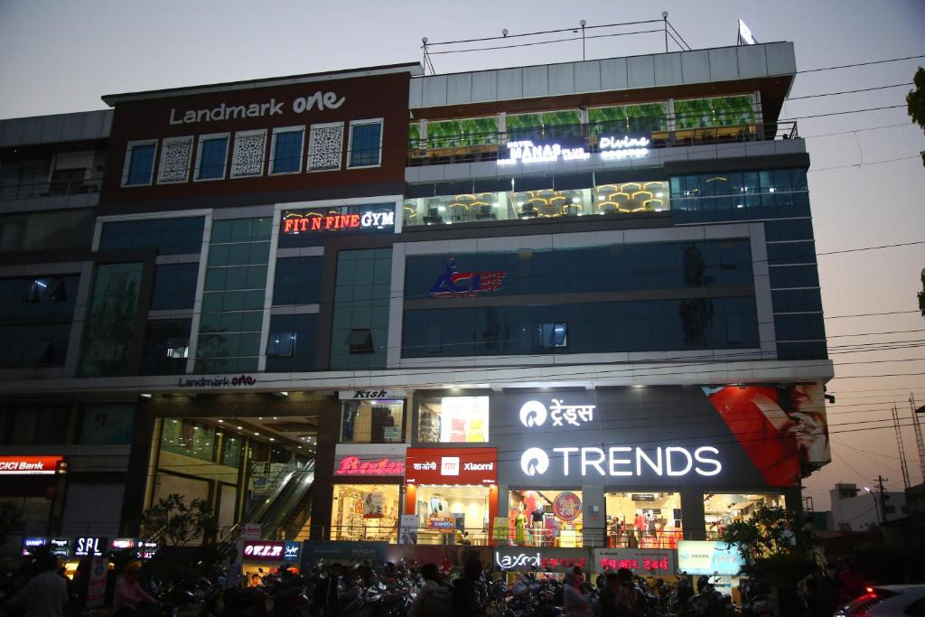 una tienda frente a un edificio con gente delante de él en Hotel Manas Plus, en Khandwa