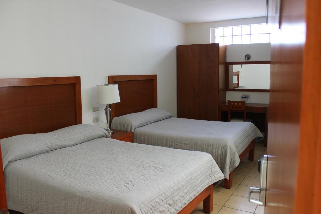Postel nebo postele na pokoji v ubytování Hotel Marllou