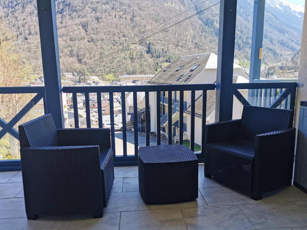 a balcony with two chairs and a view of a mountain at Appartement d'une chambre avec balcon a Cauterets in Cauterets