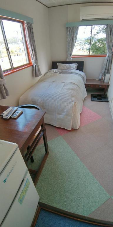 Postel nebo postele na pokoji v ubytování 田舎の宿 吉田屋