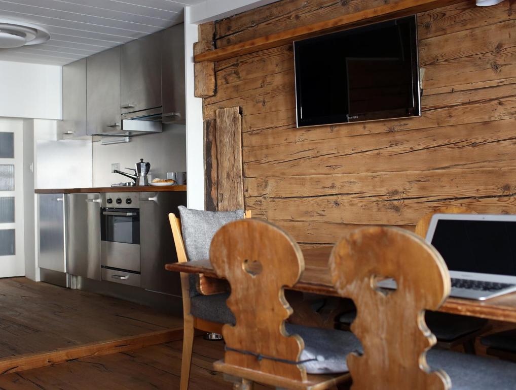 a kitchen with a desk with a laptop on it at Chalet Swiss Andermatt in Andermatt