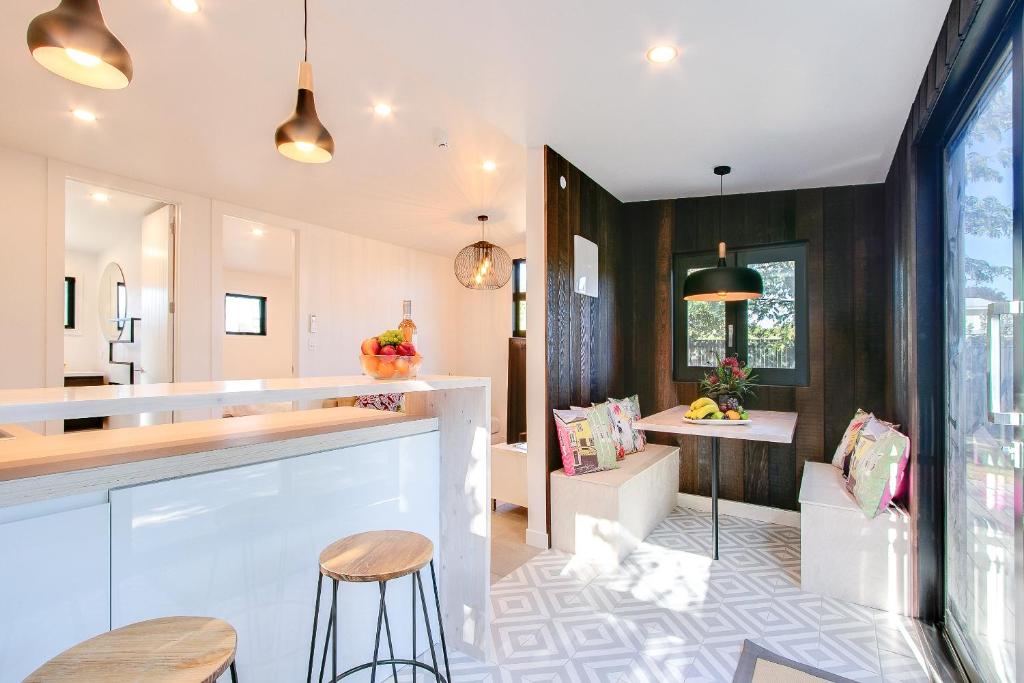a kitchen with a bar and a dining room at Beach and Vineyard Escape - Haumoana Beach Home in Haumoana